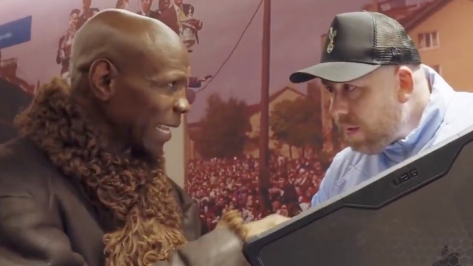 Two men looking at a tablet together.