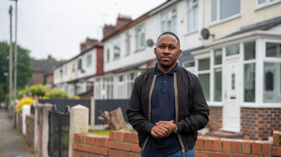 Man standing on a residential street.