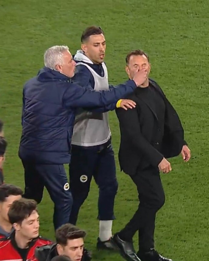 Jose Mourinho pinching Okan Buruk's nose.