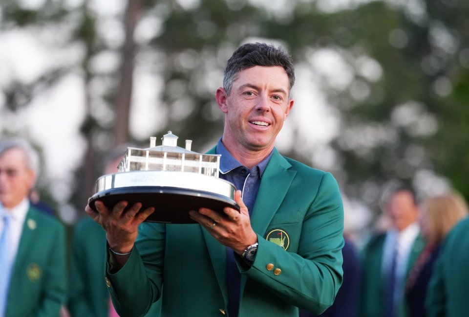 Rory McIlroy holding the Masters Tournament trophy.