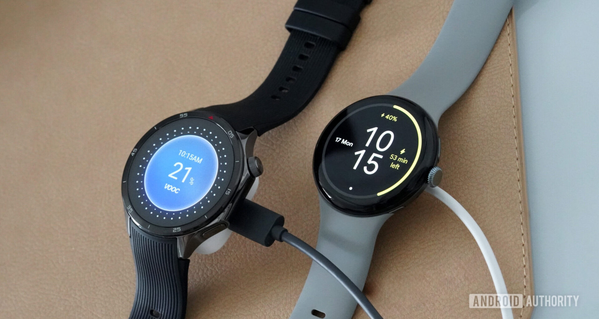 A OnePlus Watch 3 rests along a Pixel Watch 3, both on their chargers.