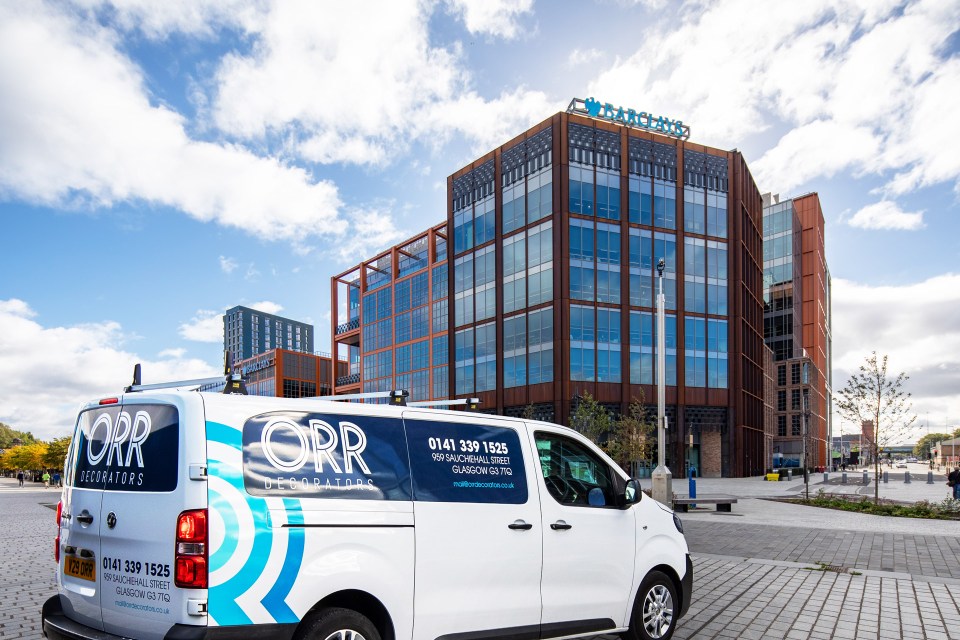 Orr Decorators van parked in front of a building.
