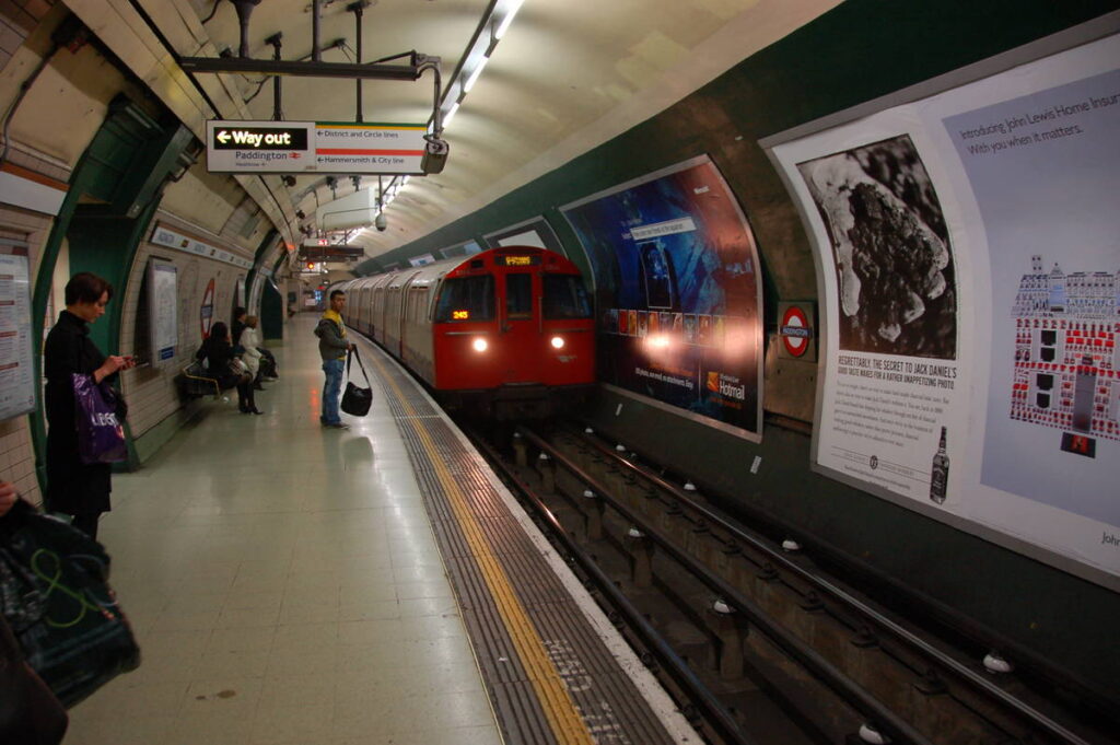 A train pulling into the platform at at Paddington underground station