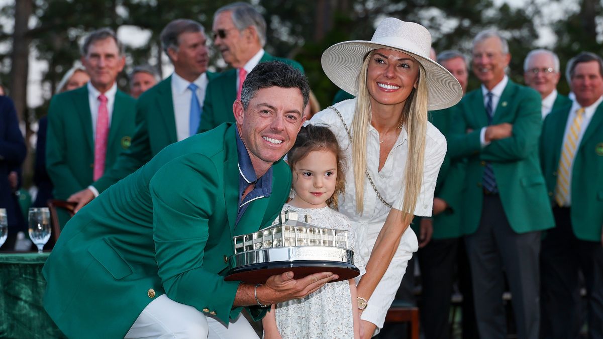 Rory McIlroy of Northern Ireland poses with daughter Poppy and wife Erica Stoll holding the Masters trophy during the Green Jacket Ceremony after winning the 2025 Masters Tournament