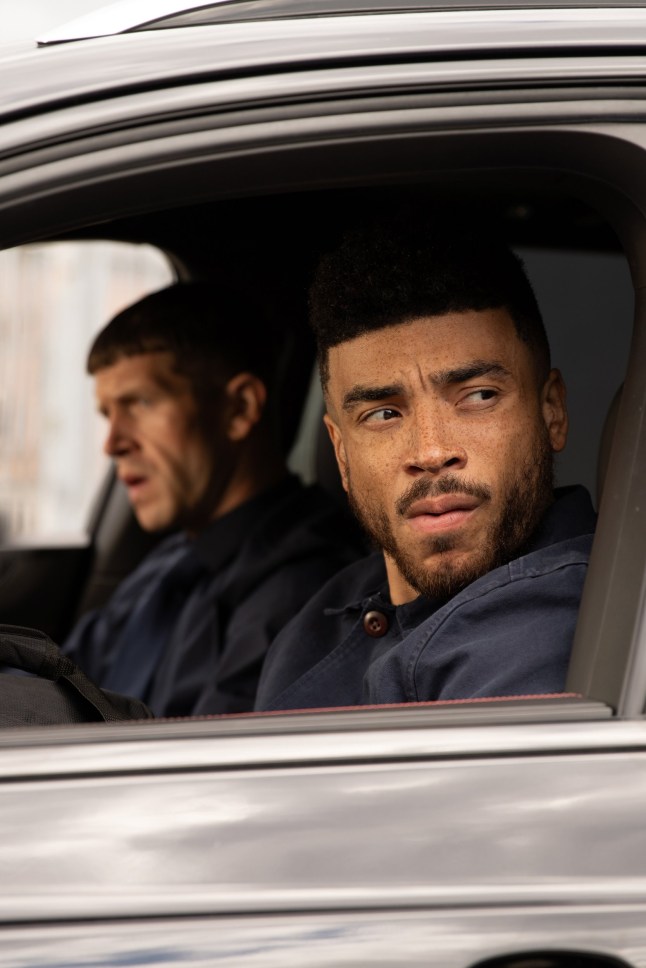 Nate looks curious in a car in Emmerdale