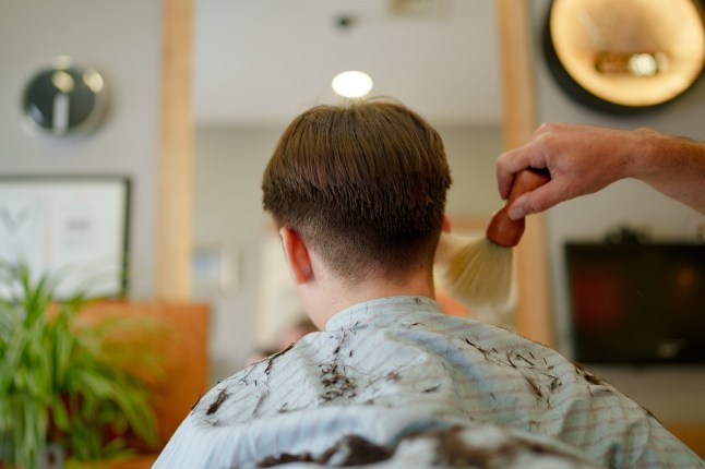 Part of a series of a boy having hair cut at the barber shop.