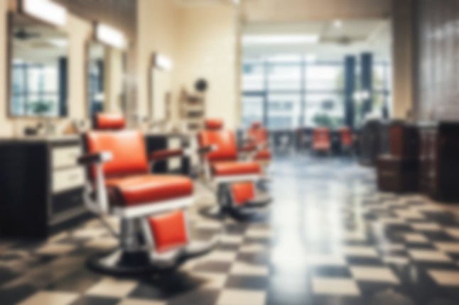 Blurred barbershop background. Background without people. Defocused barbershop interior.