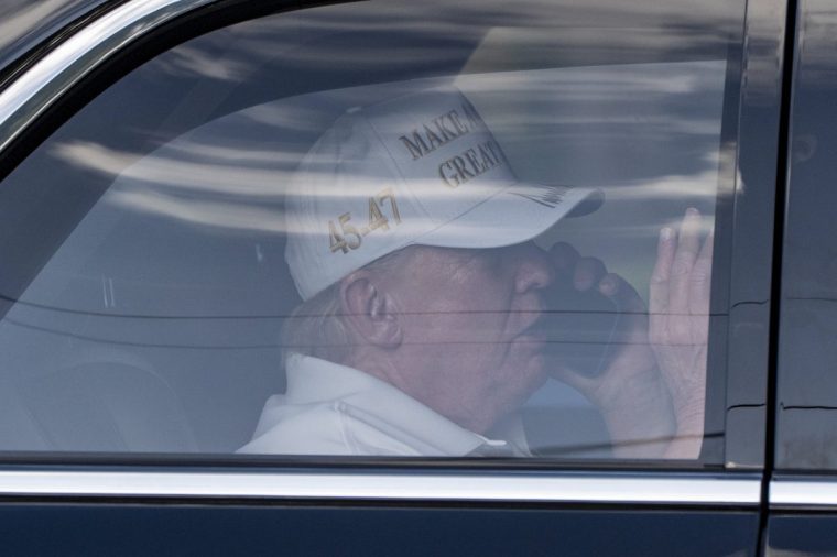President Donald Trump talks on the phone as he arrives at Trump National Golf Club, Sunday, April 6, 2025, in Jupiter, Fla. (AP Photo/Alex Brandon)