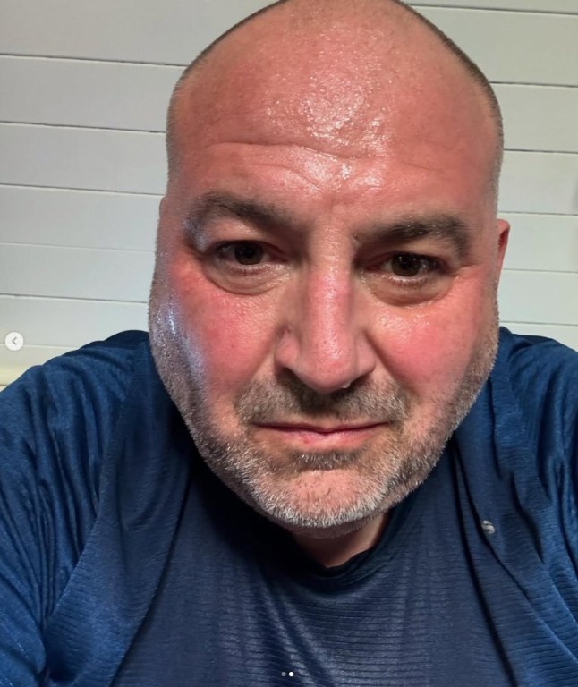 Wynne Evans in blue shirt as he takes a selfie