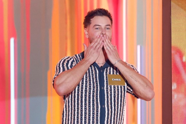 Chris Hughes with his hand over his mouth as he enters the Big Brother house