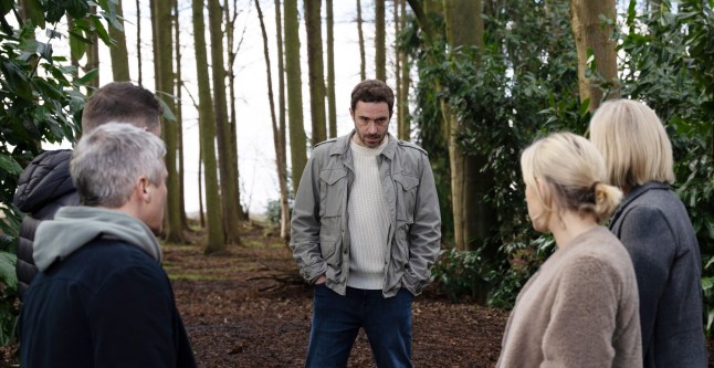 John and Anthony's killers gather round the supposed grave in Emmerdale