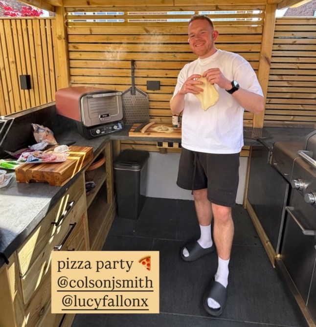 Colson Smith holding pizza dough in a garden