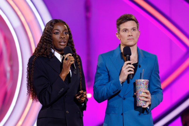 Celebrity Big Brother presenters AJ Odudu and Will Best holding microphones on eviction night