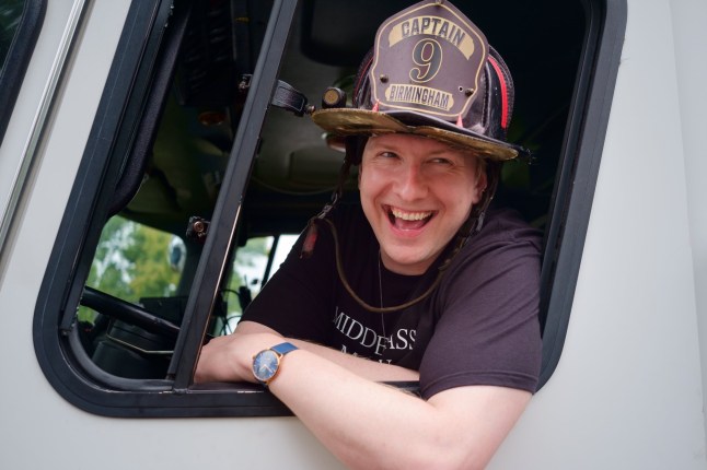 A still from Joe Lycett's new show The United States of Birmingham showing Joe in the front seat of a white transit van.