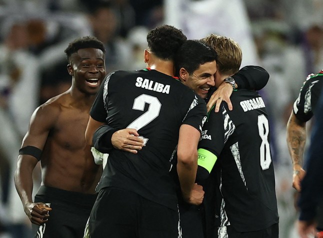 Soccer Football - Champions League - Quarter Final - Second Leg - Real Madrid v Arsenal - Santiago Bernabeu, Madrid, Spain - April 16, 2025 Arsenal manager Mikel Arteta, Bukayo Saka, William Saliba and Martin Odegaard celebrate after the match Action Images via Reuters/Lee Smith