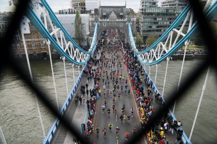 LONDON, ENGLAND - APRIL 21: Runners cross Tower Bridge during the 2024 TCS London Marathon at on April 21, 2024 in London, England. The 2024 TCS London Marathon is the 43rd to be run over 26-miles around the capital, Competitive runners typically take between, two and a half to three and a half hours and recreational runners take between four and five hours to complete the distance (Photo by Alishia Abodunde/Getty Images)