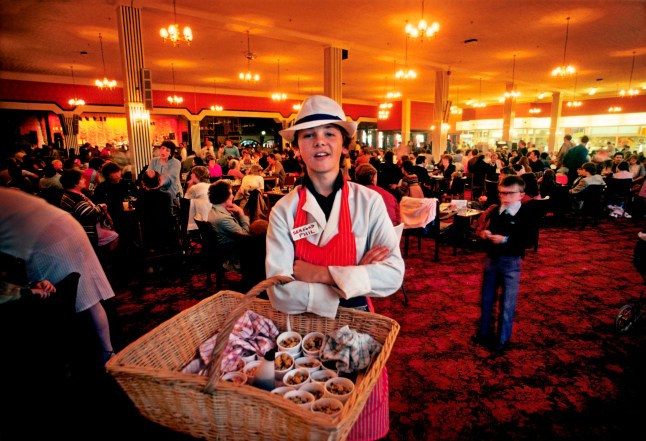 Boy selling seafood in the bar at Butlins holiday camp, Skegness. Butlins Skegness is a holiday camp located in Ingoldmells near Skegness in Lincolnshire. Sir William Butlin conceived of its creation based on his experiences at a Canadian summer camp in his youth and by observation of the actions of other holiday accommodation providers, both in seaside resort lodging houses and in earlier smaller holiday campsThe camp began opened in 1936, when it quickly proved to be a success with a need for expansion. The camp included dining and recreation facilities, such as dance halls and sports fields. Over the past 75 years the camp has seen continuous use and development, in the mid-1980s and again in the late 1990s being subject to substantial investment and redevelopment. In the late 1990s the site was re-branded as a holiday resort, and remains open today as one of three remaining Butlins resorts. (photo by Barry/In Pictures via Getty Images Images)