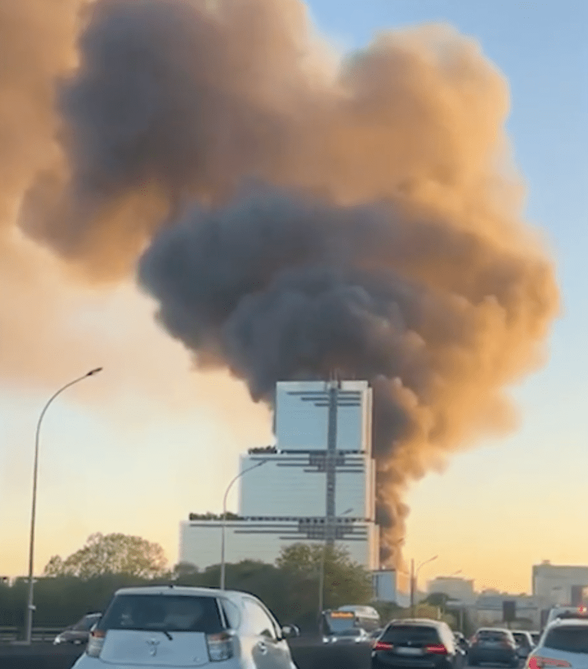 Large plume of smoke billowing from a building fire.