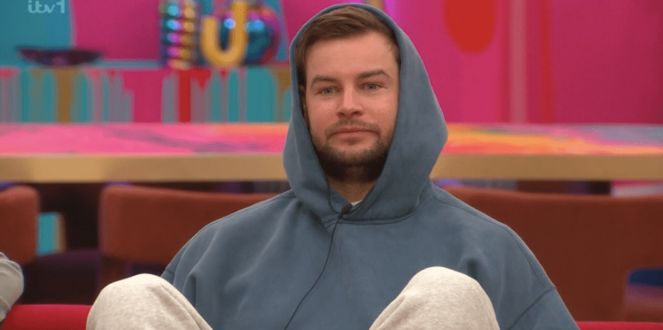 Screenshot of a man in a blue hoodie.