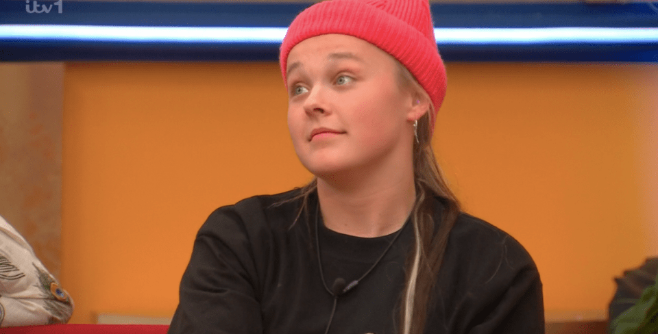 Screenshot of a young woman wearing a pink beanie.