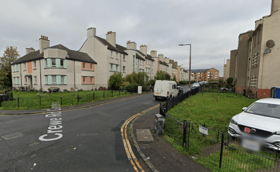 Street view of residential buildings and a van.