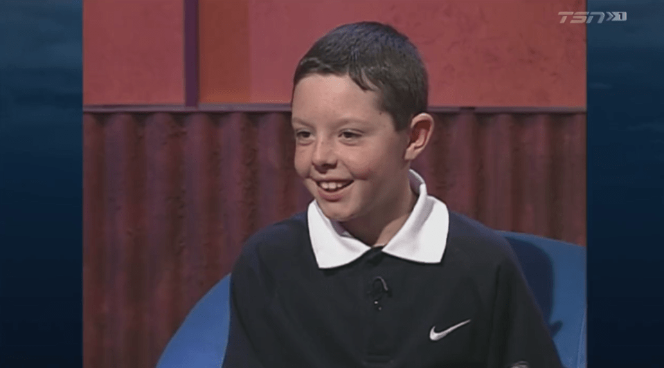 Screenshot of a young boy smiling during an interview.