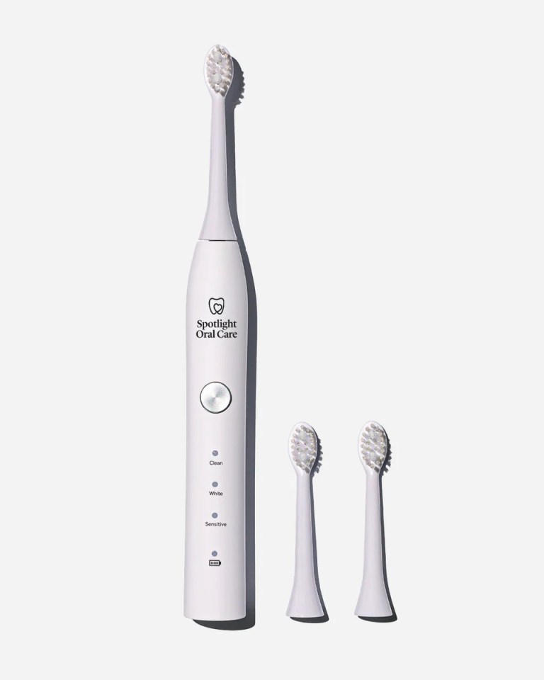 Spotlight Oral Care electric toothbrush with two replacement brush heads.
