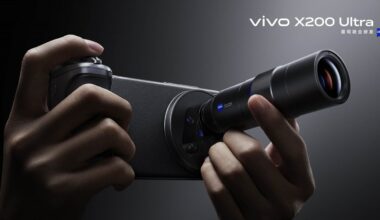 Close-up of hands holding a Vivo X200 Ultra smartphone with an attached external lens, highlighting advanced photography features. The phone is black and the lens is prominently visible.