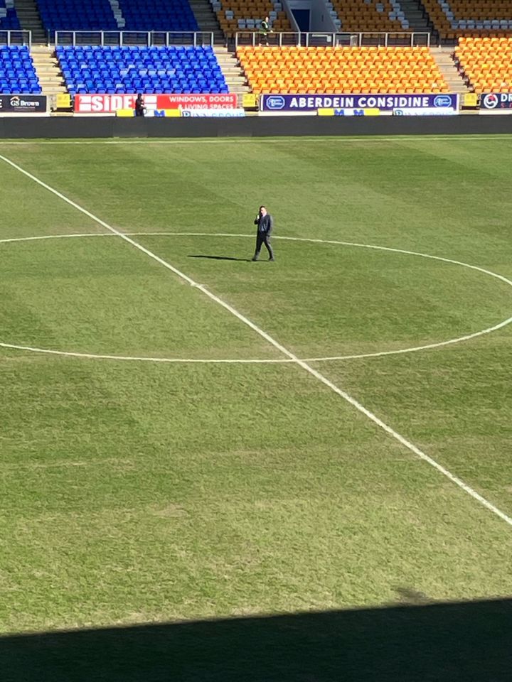 Person standing on a soccer field.