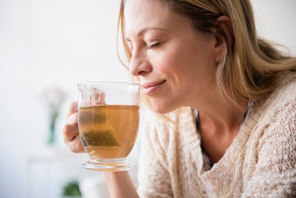 Woman happy smiling drinking green tea