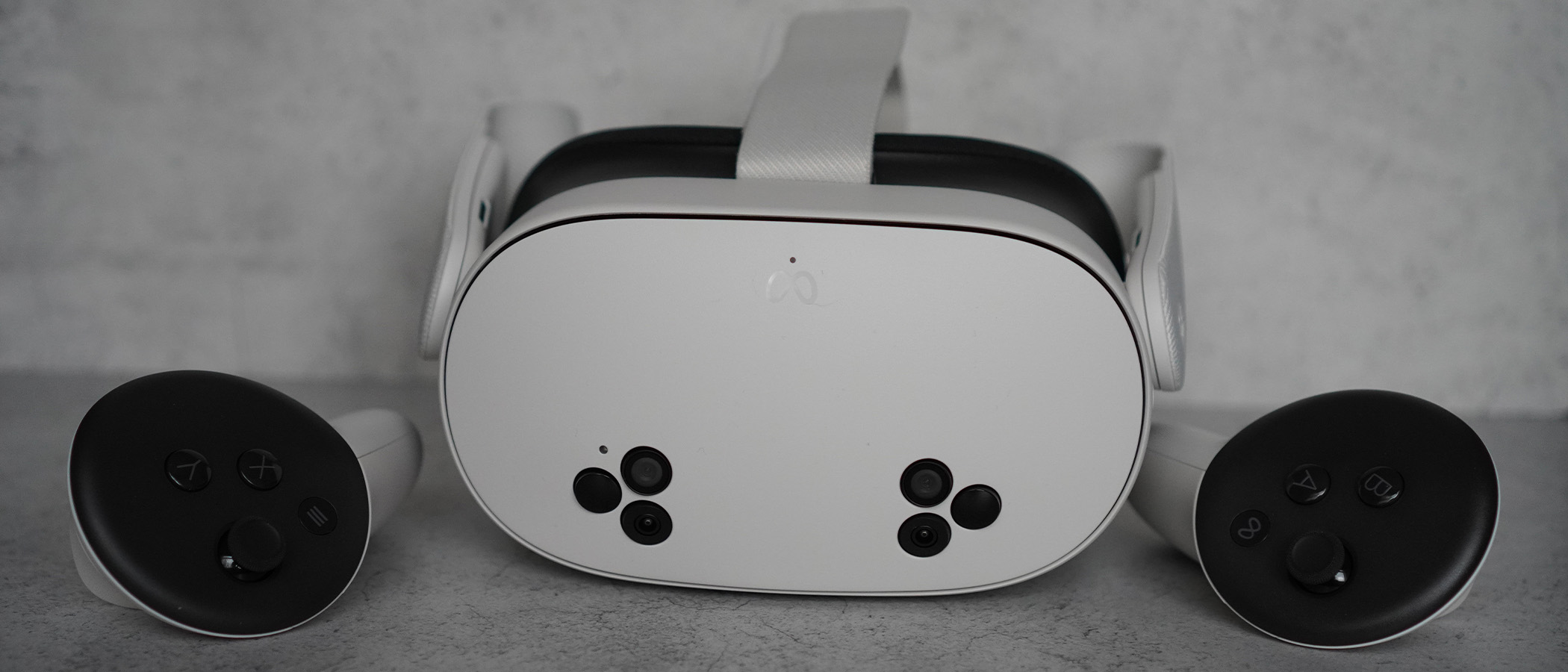 Meta Quest 3S headset and controllers on a grey background