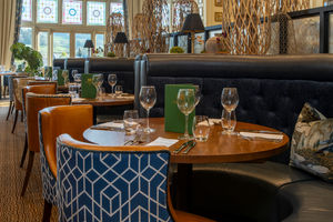 Comfortable chairs and glistening cutlery, ready for a meal to remember. 