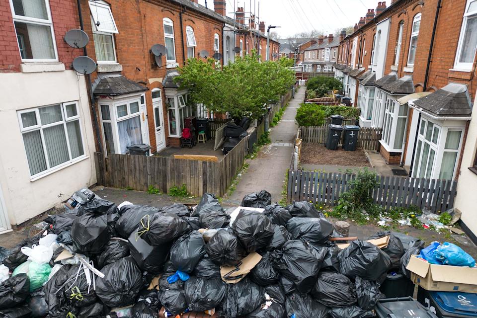 Primrose Avenue, Sparkbrook, Birmingham, 15th April 2025: A huge mountain of rubbish bags and other waste block an avenue to a street of terraced housing on Primrose Avenue in the Sparkbrook area of Birmingham as refuse workers continue to strike with the backing of the Unite Union with many areas in Birmingham still suffering as waste is left outside of homes and businesses.  Credit: British News and Media/Alamy Live News