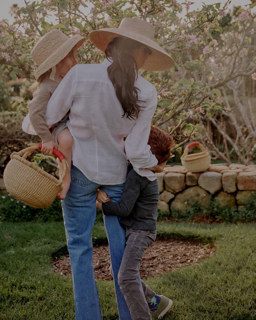 Meghan with Archie and Lilibet in the garden