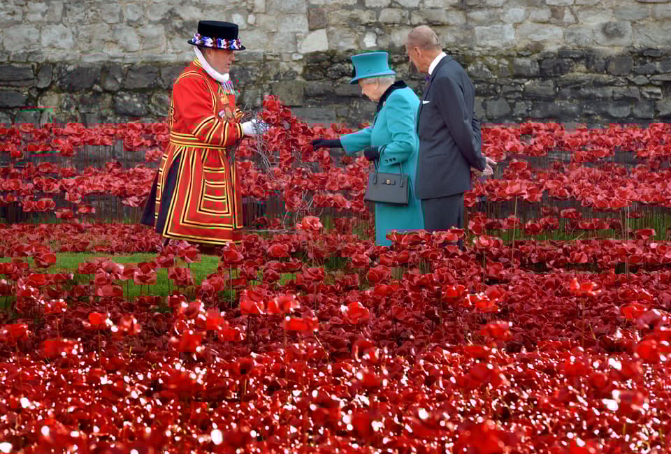 The Queen and the Duke of Edinburgh viewing ceramic poppies around the Tower in 2014.