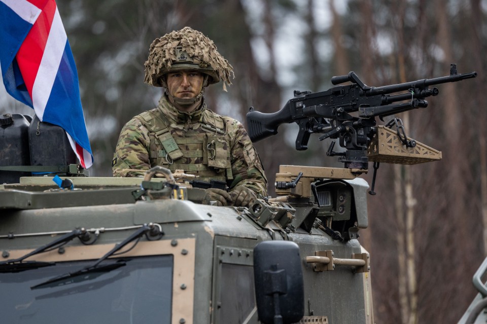 British soldier in a military vehicle during a NATO exercise.
