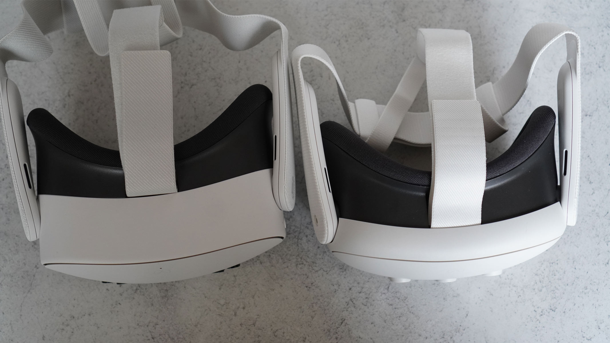 The Meta Quest 3S is a white headset with black cameras on the front and white controllers on a gray background