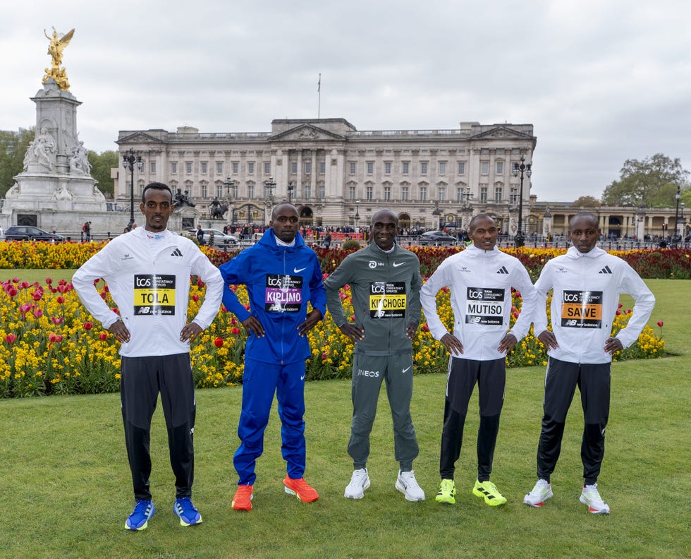 group of marathon runners posing outdoors at a landmark