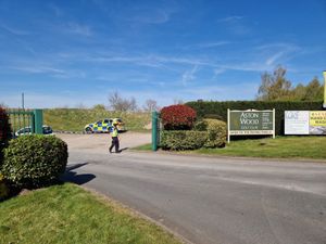 A police cordon is in place at the entrance to Aston Wood Golf Club