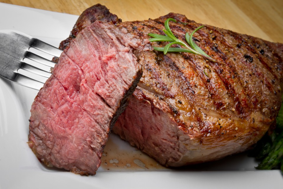 Grilled rib-eye steak with asparagus.
