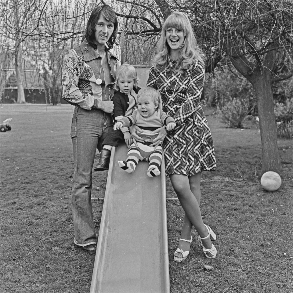 Black and white photo of singer Len "Chip" Hawkes with his family on a slide.