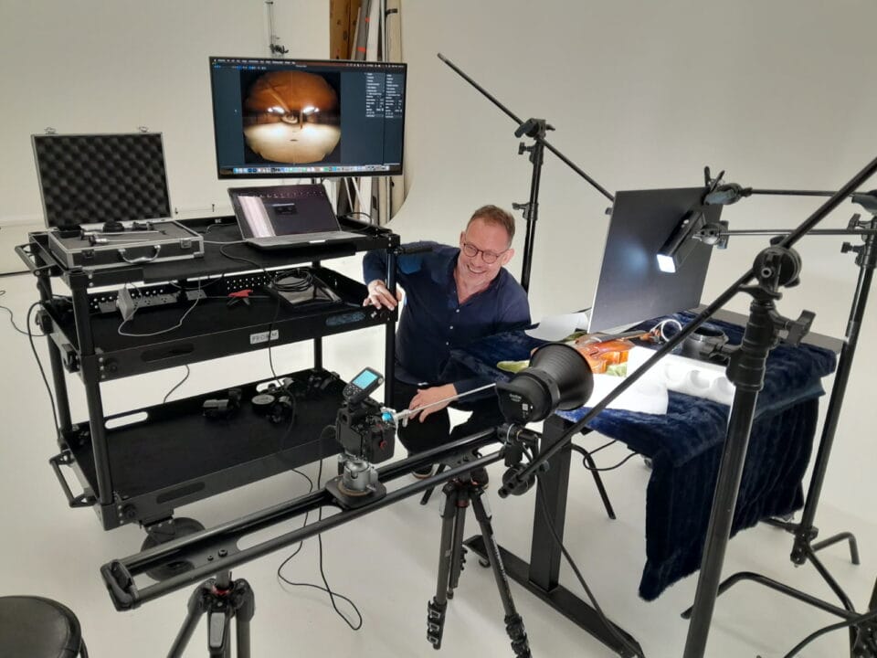 an artist at work in a studio with a photography setup