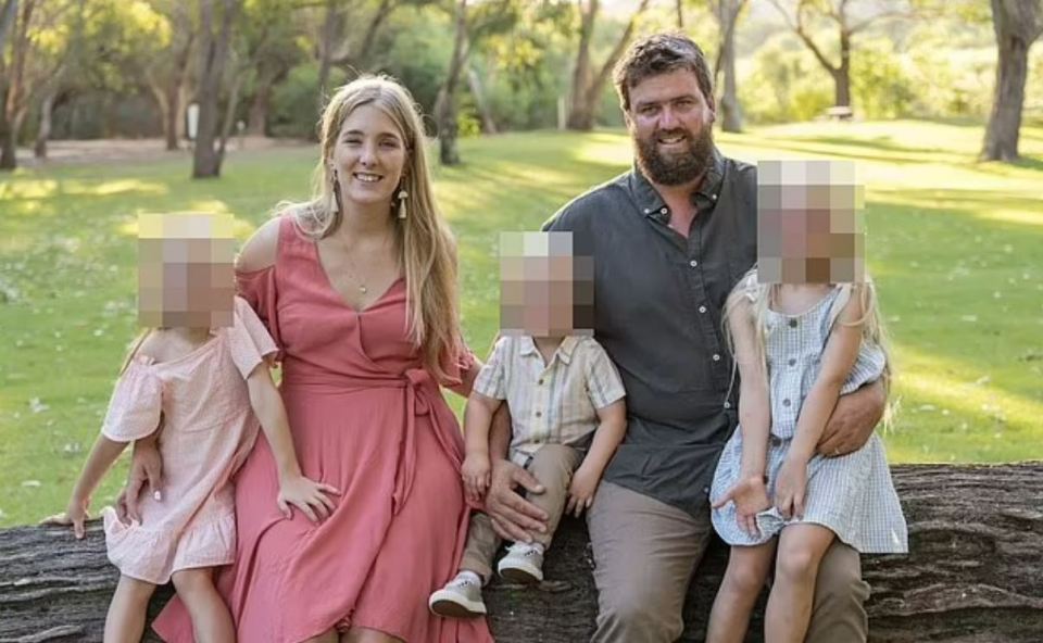 Family photo of parents and three children sitting on a log.  Children's faces are blurred.
