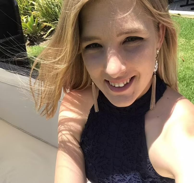 Woman in a dark halter top.