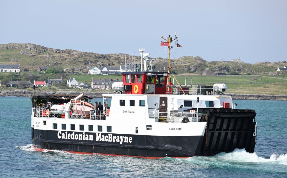 The Loch Buie ferry, operated by Caledonian MacBrayne, travels through the water.