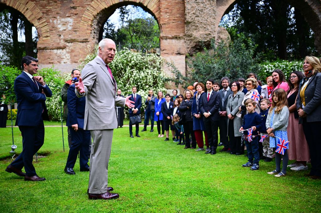 King Charles speaking to guests in garden of Villa Wolkonsky
