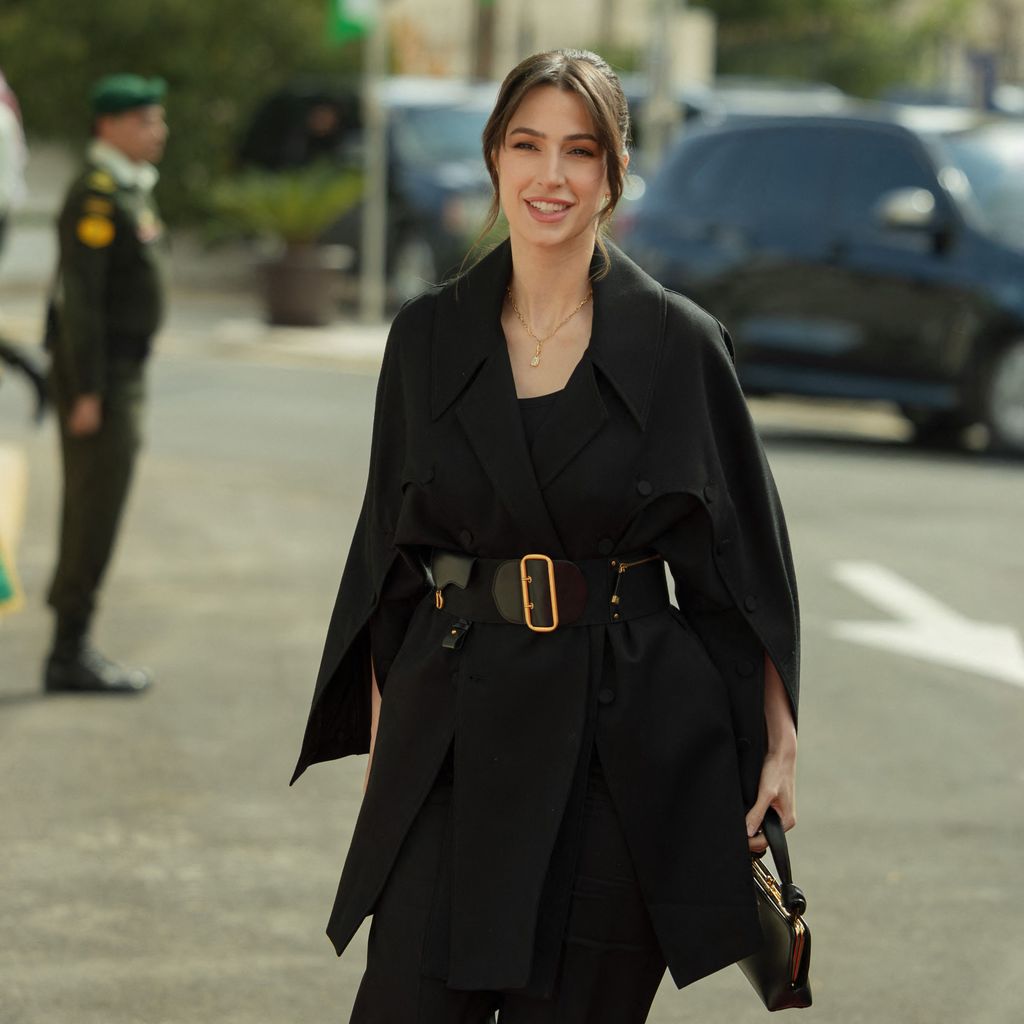 Princess Rajwa in a black coat with her hair up