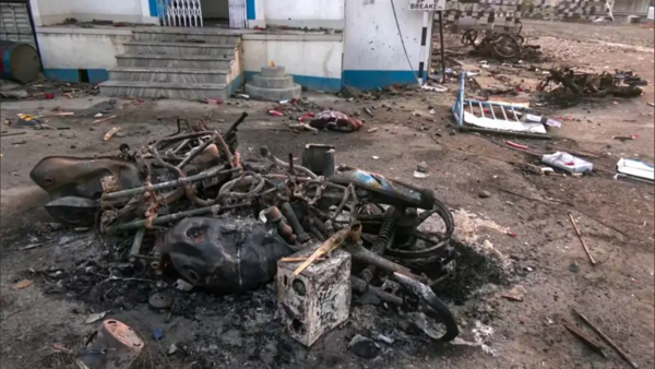 Charred remains of a vehicle following a protest against the Waqf Amendment Act, at Jangipur in Murshidabad on Saturday.