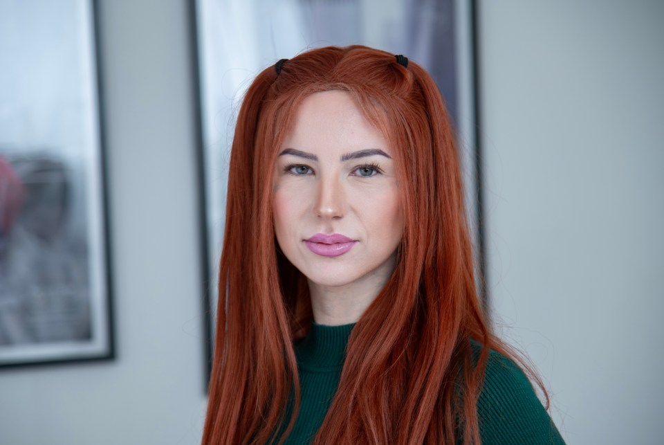 Portrait of a young woman with long, red hair.