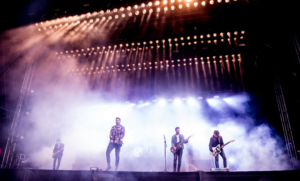 You Me At Six performing on stage at a music festival.